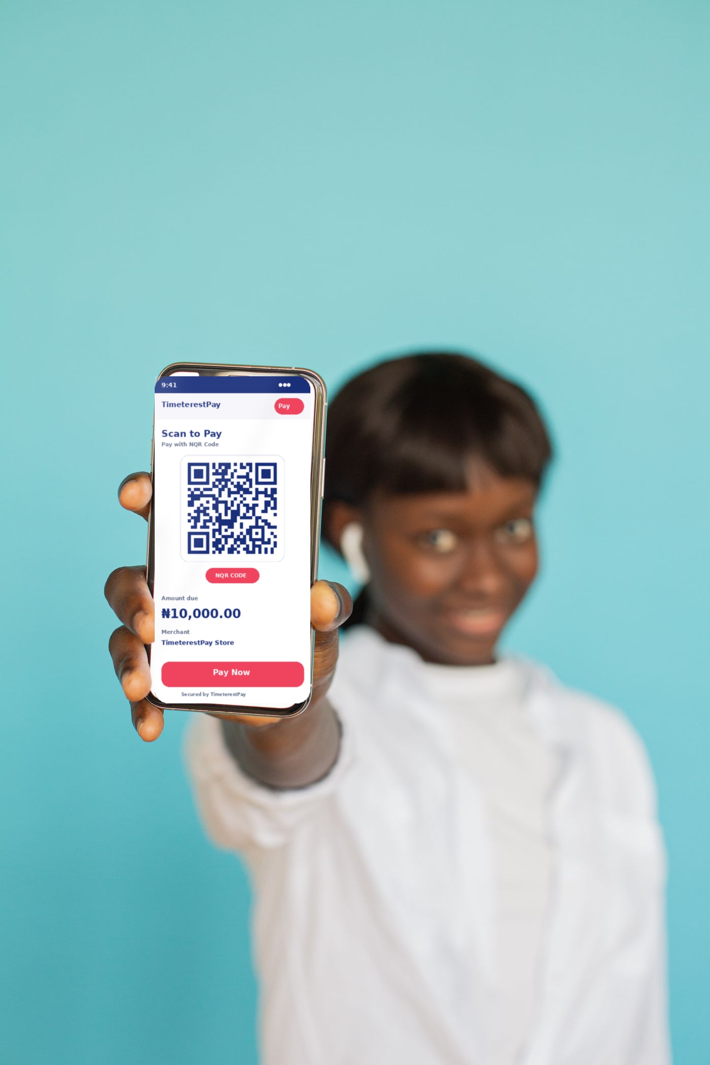 African businesswoman paying with TimeterestPay NQR Code